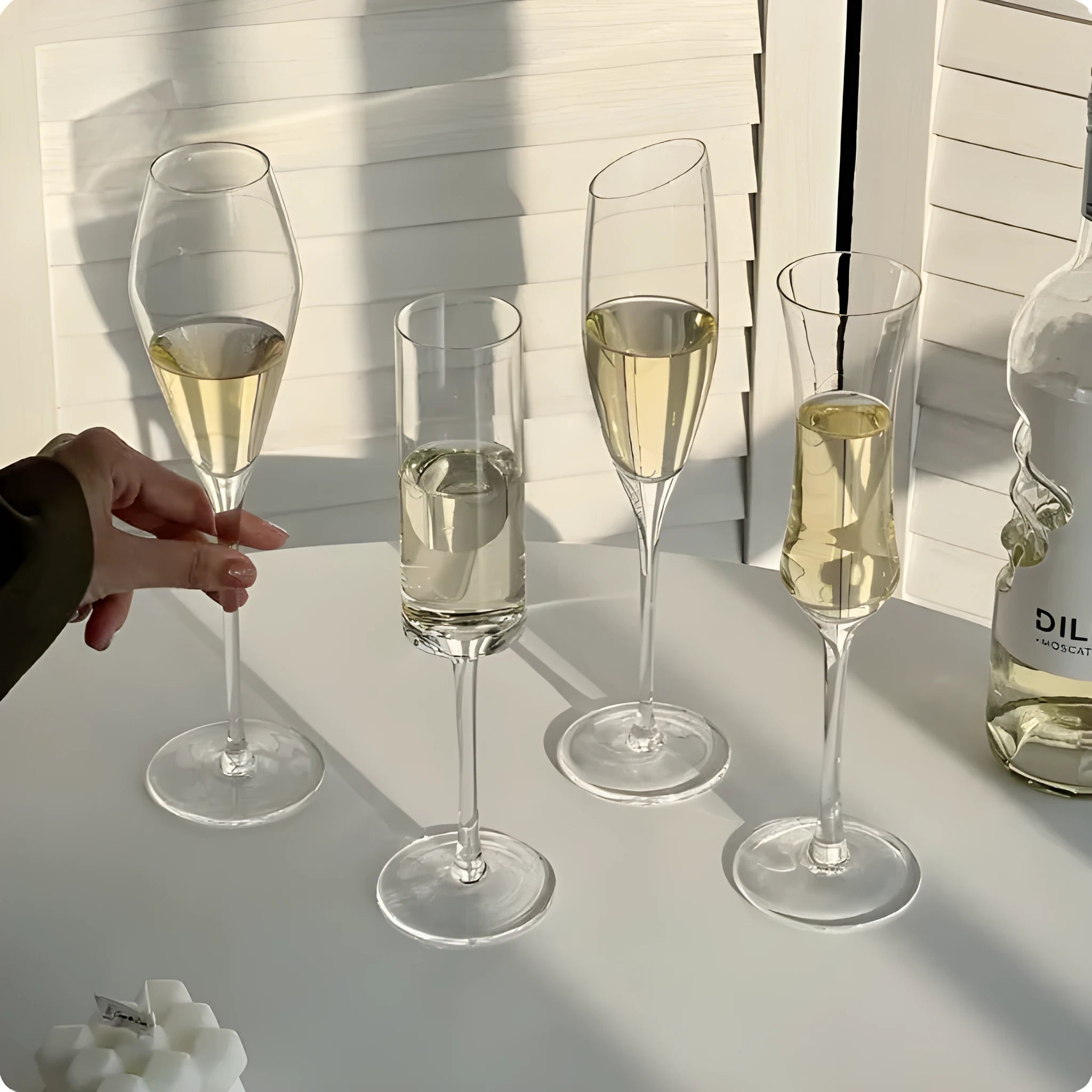 Set of six French-design champagne glasses in various crystal goblet styles including tulip and flute shapes