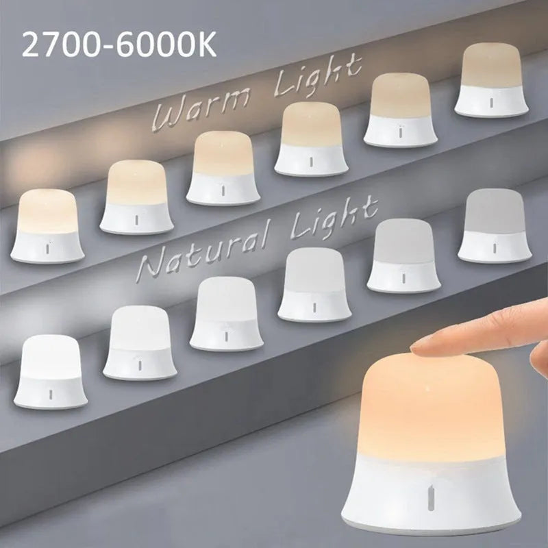White cylindrical touch control bedside night light with USB charging cable.