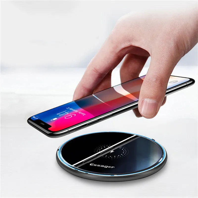Black aluminium alloy 15W Qi fast wireless charging pad on a wooden desk