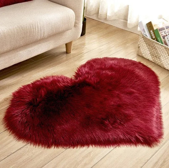 Heart-shaped plush carpet in multiple colours showing wool-like texture with 5-6 cm pile length