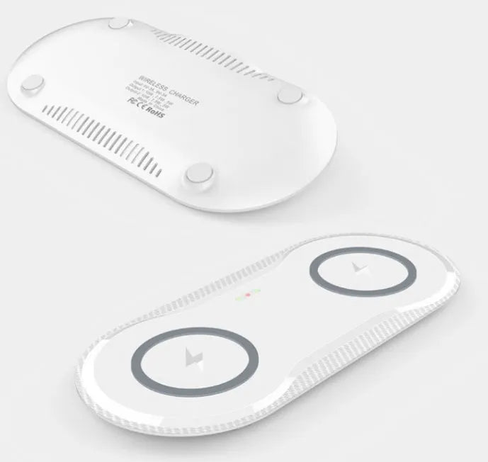Black and white dual wireless charging pad charging two smartphones simultaneously