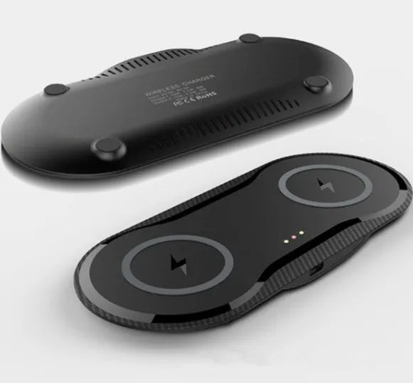 Black and white dual wireless charging pad charging two smartphones simultaneously