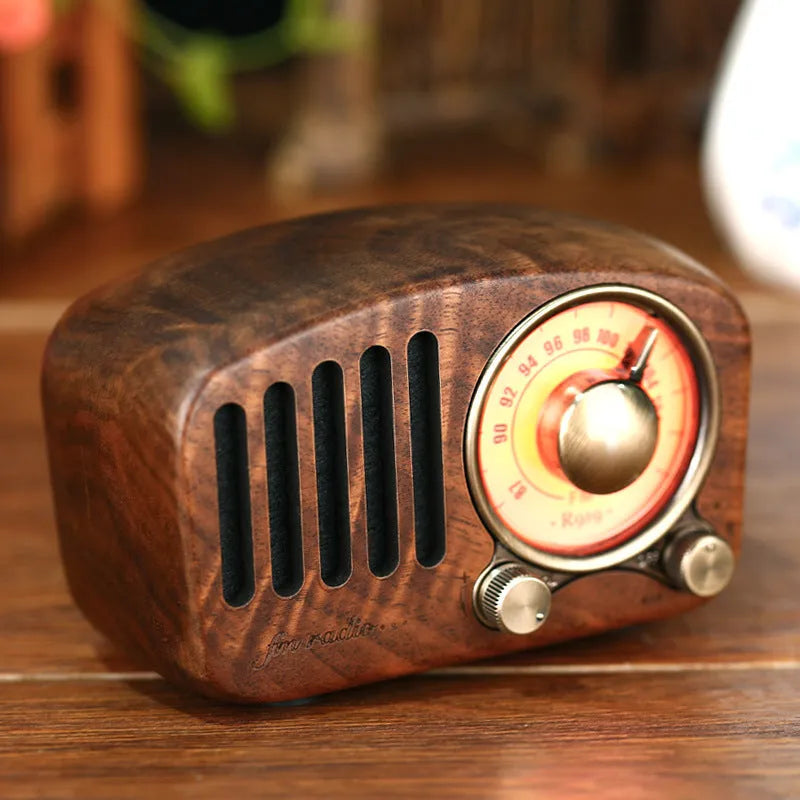 Retro wooden mini Bluetooth speaker in walnut finish showing front grille and side USB port