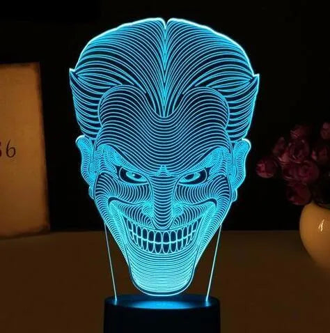 USB-powered 3D acrylic LED lamp displaying multiple colours on a desk with remote control.