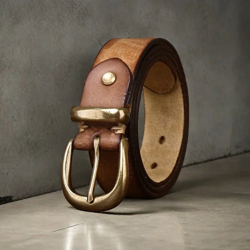 Men's brown casual leather belt with a copper pin buckle shown on a pair of jeans