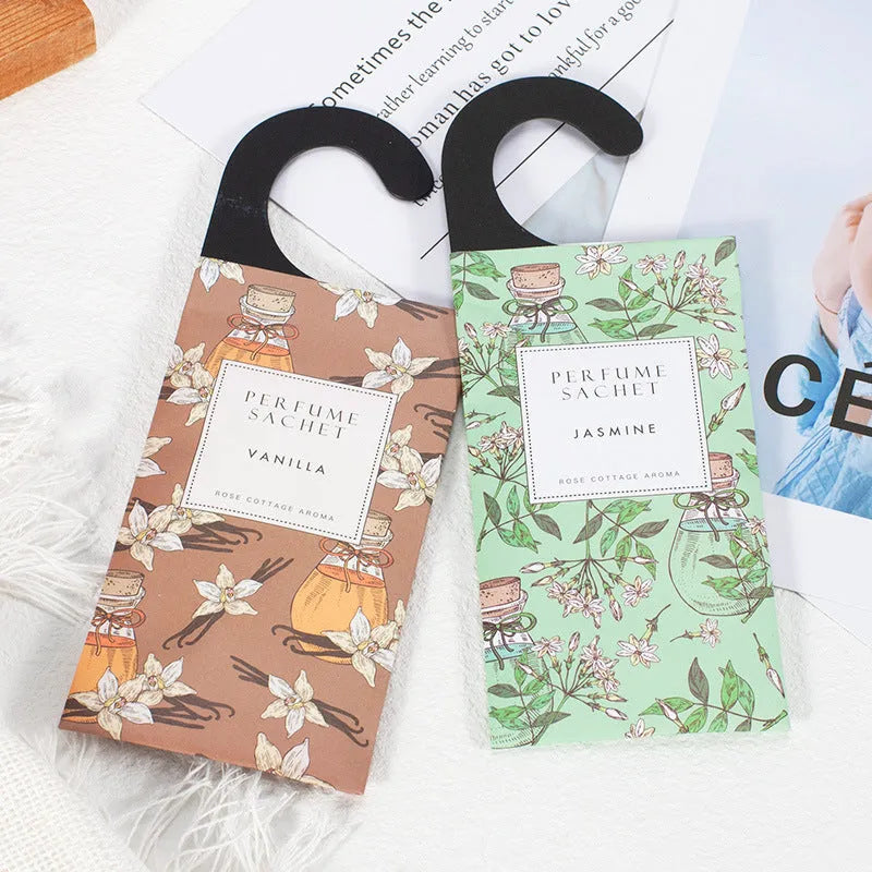 Pack of five household wardrobe sachets with lavender, rose, jasmine, sandalwood, vanilla, apricot blossom aromas on a shelf