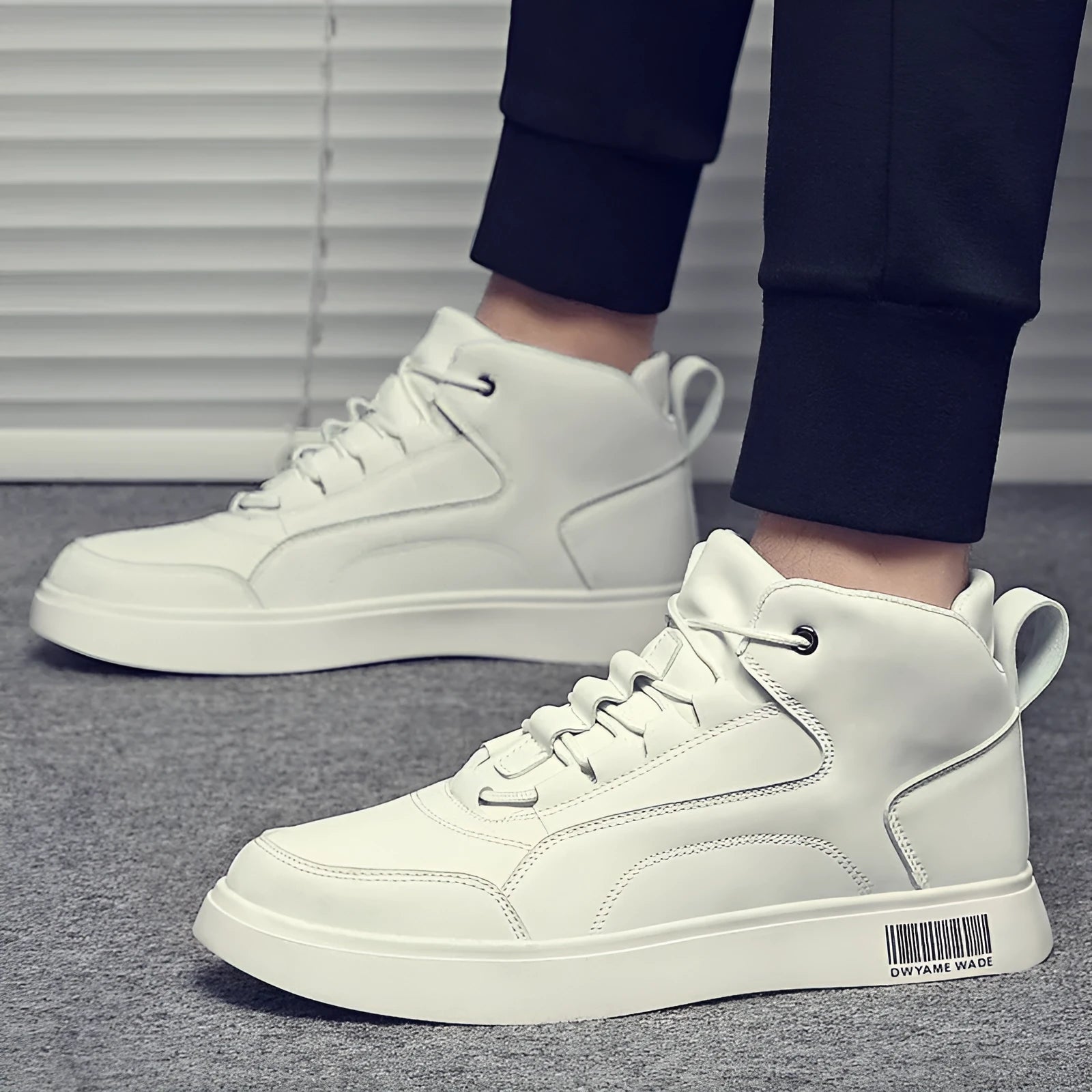Men's white mid-top casual lace-up board shoes with a flat rubber sole on a solid background.