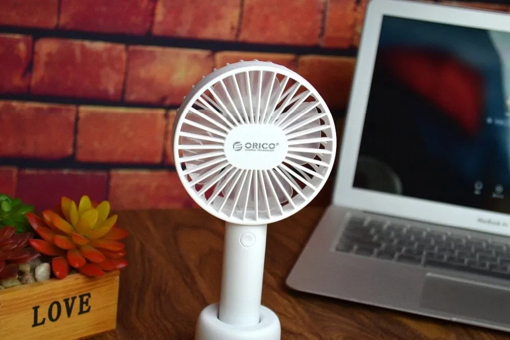 White ORICO FH1 portable USB rechargeable desk fan with three-speed buttons and compact handheld design.