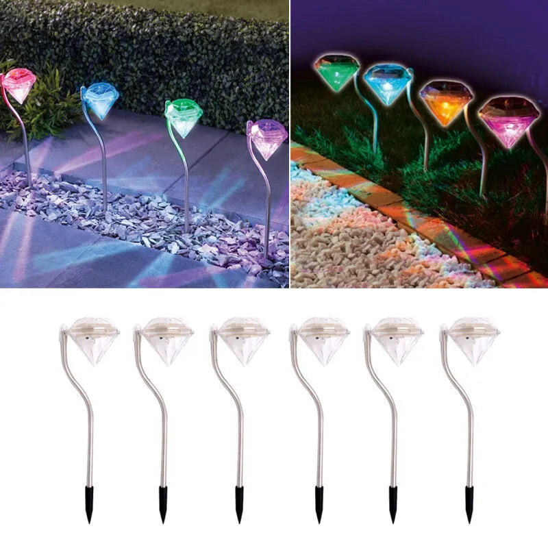 White solar-powered garden spotlight with adjustable lighting angle on a fence post.
