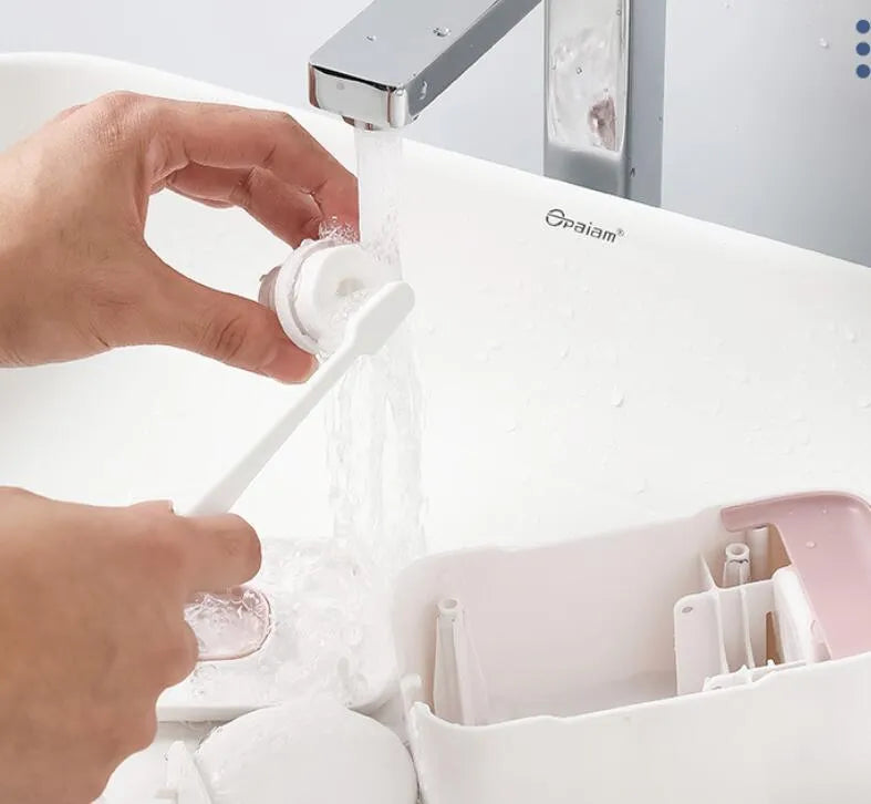 Blue automatic toothpaste dispenser made of ABS plastic mounted on a bathroom wall.