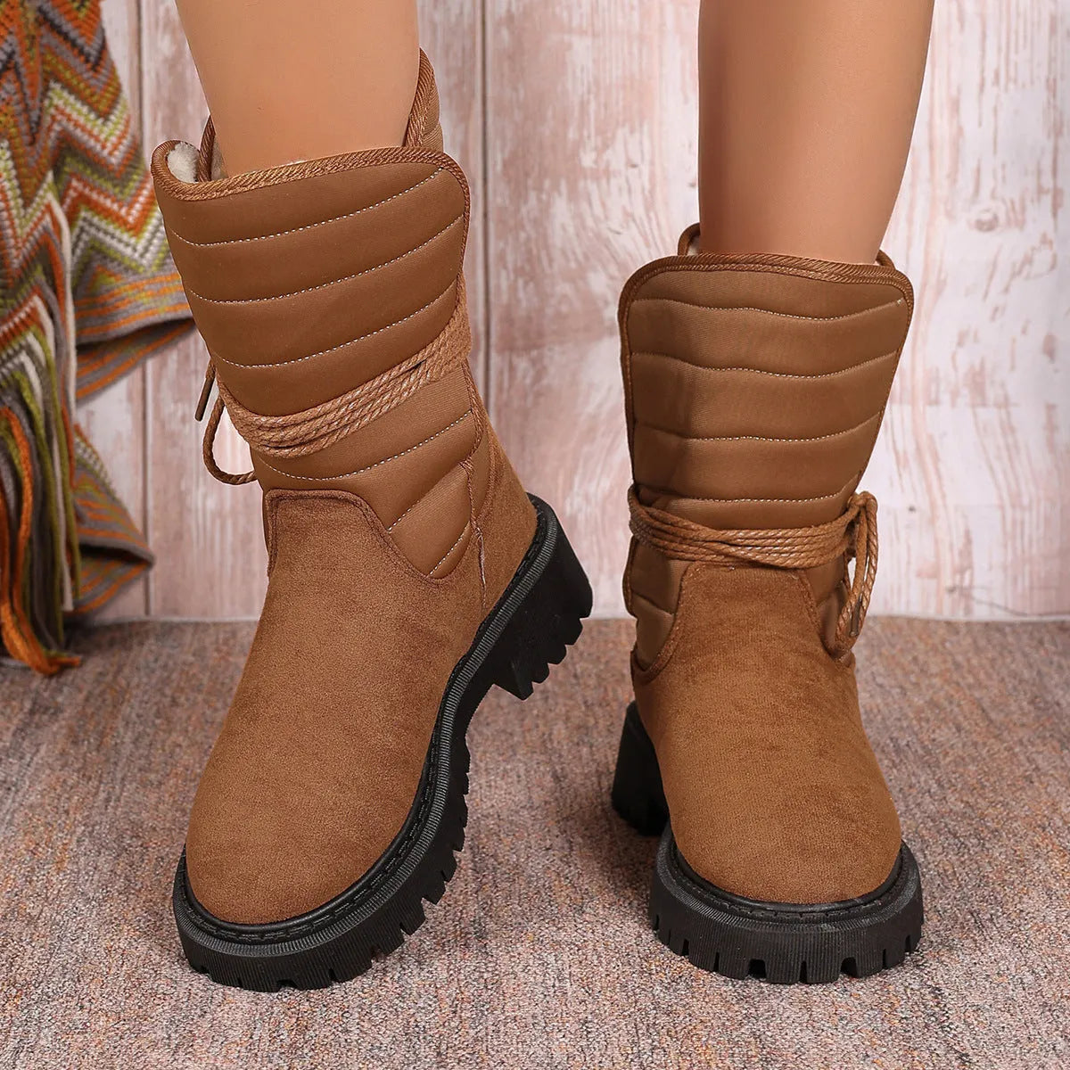 Women's black chunky heel snow boots with lace-up design and fleece lining on a high-top suede upper.