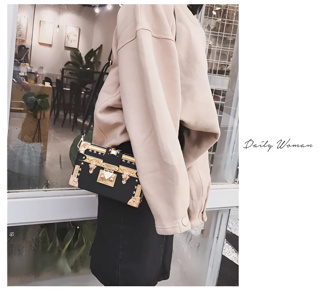 Women's black structured PU leather flap shoulder bag with cross-body strap and rivet details.