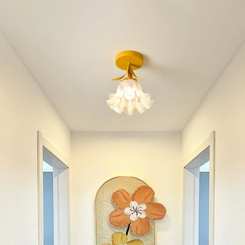 Cream coloured Linglan flower inspired corridor wall light with modern simple design on a white background.