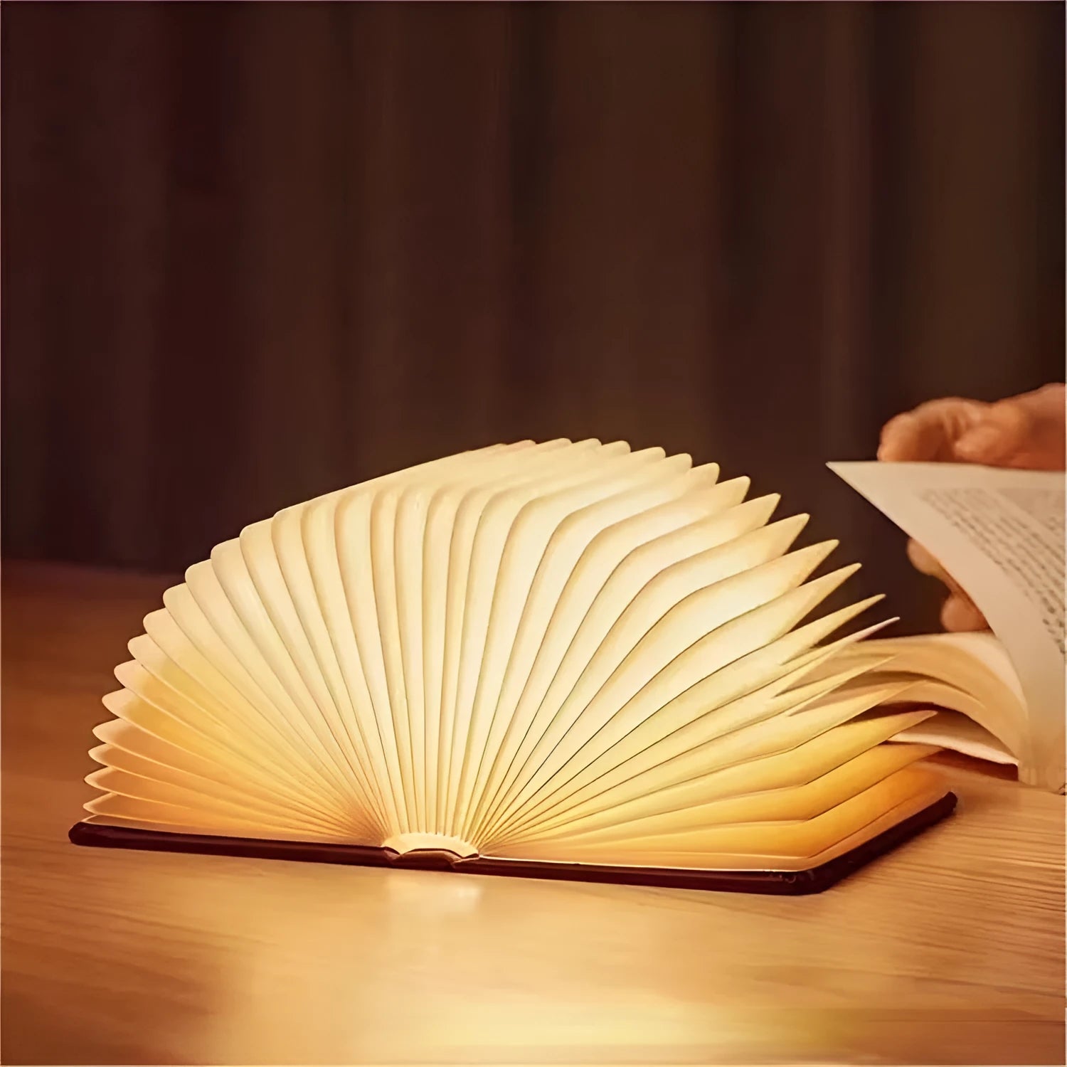Leather folding night lamp in tricolour lighting on a wooden surface, size small book 10x8x2.5cm