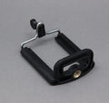 Black octopus tripod with flexible legs and spherical gimbal ball head for cameras and smartphones