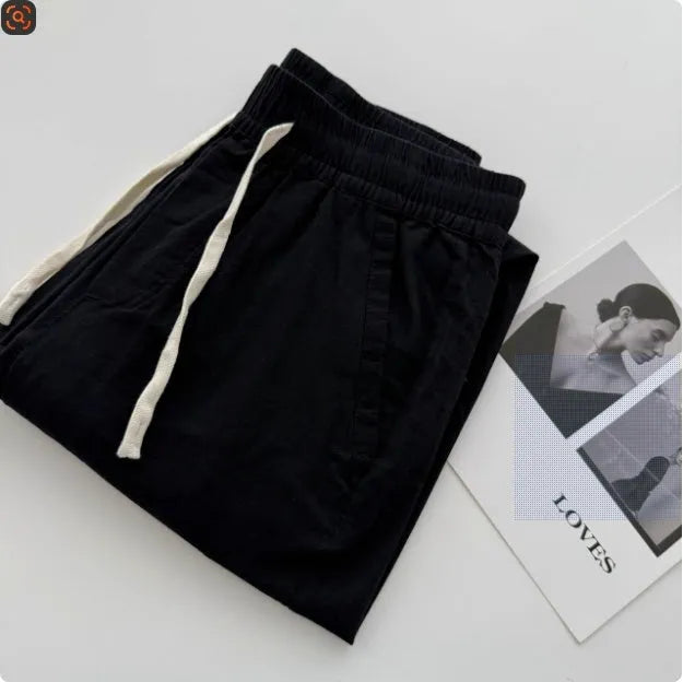 Men's loose fit straight leg casual trousers in beige with a drawstring waistband.