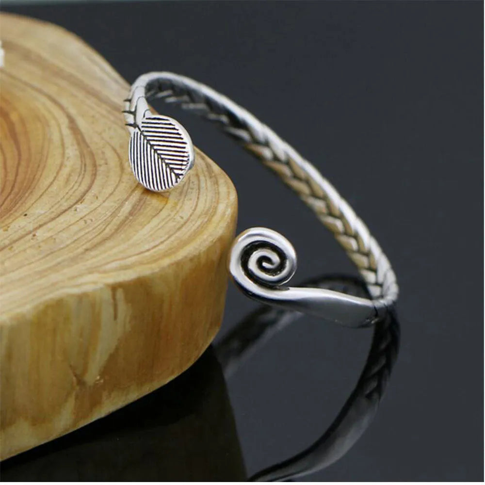 Women's silver-toned bracelet with Chinese retro fish design and magnetic clasp.