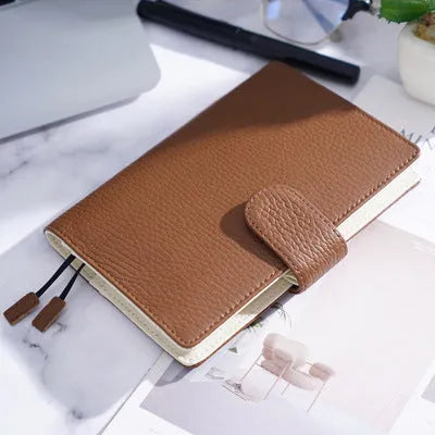 A6 loose-leaf diary with cowhide leather cover showing lychee pattern texture