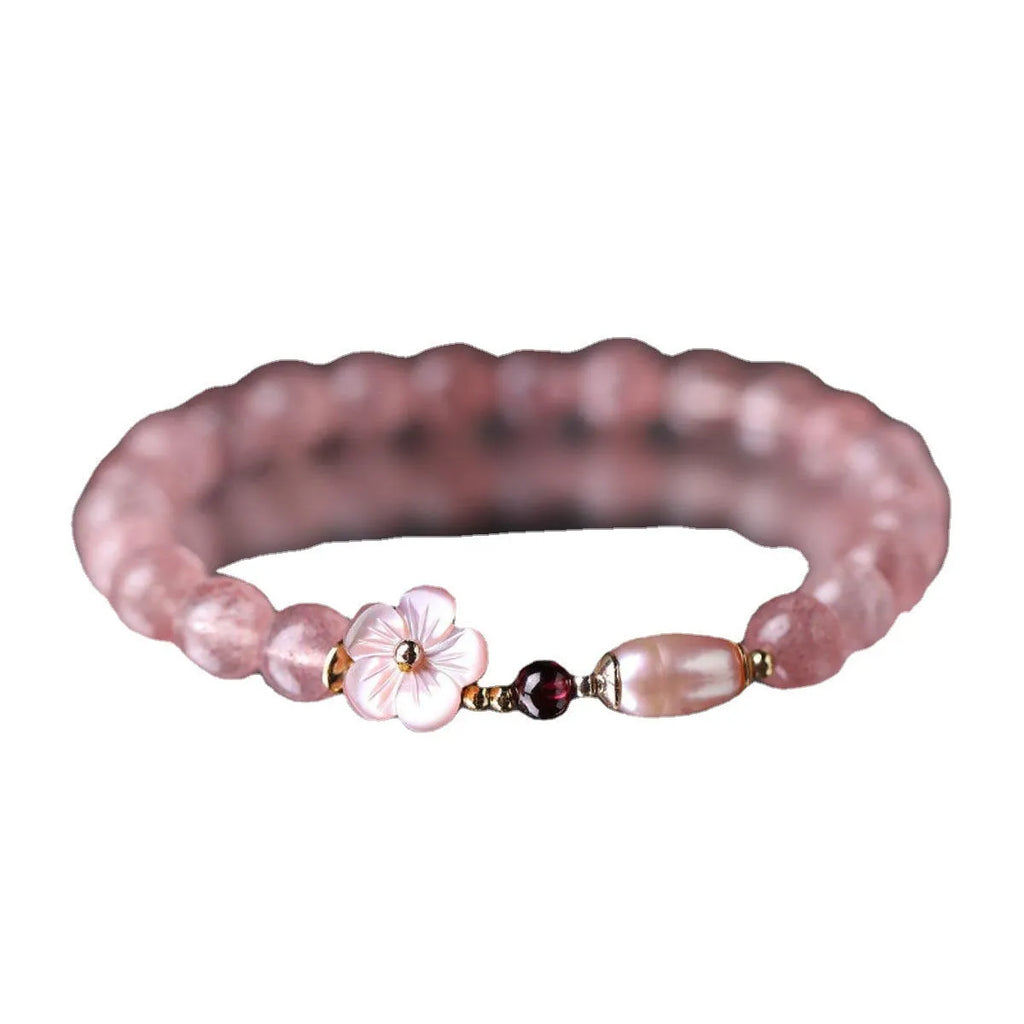Women's strawberry quartz crystal flower bracelet showing peach blossom charm bead detail