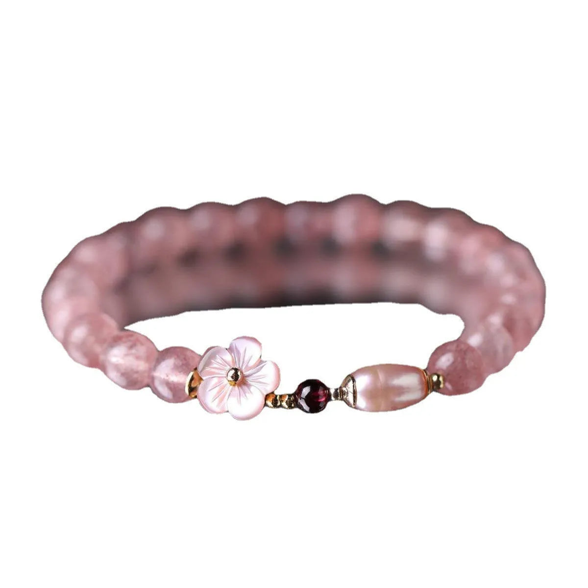 Women's strawberry quartz crystal flower bracelet showing peach blossom charm bead detail