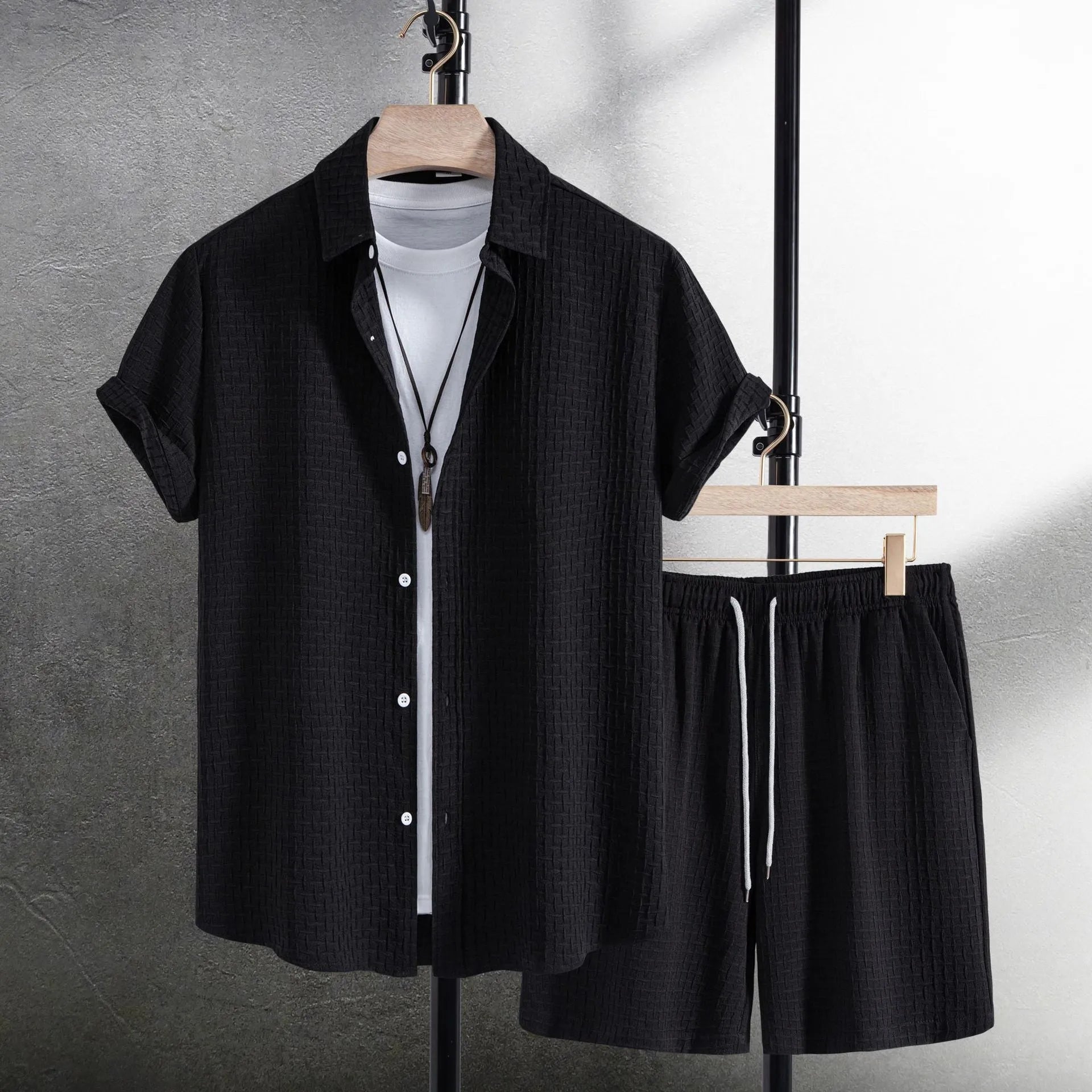 Men's black cotton blend beach suit with loose cardigan shirt and matching shorts.