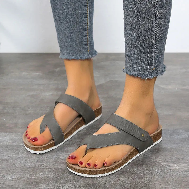 Blue thick-soled flat toe ring flip-flops on a white background.