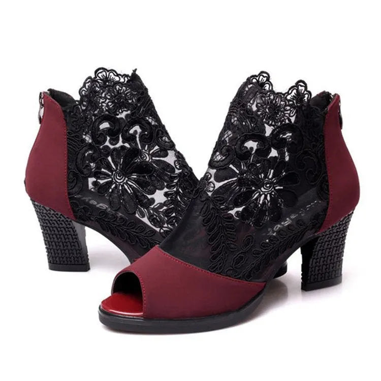 Black women's gladiator sandals with flower lace upper, square heel, and back zip closure.