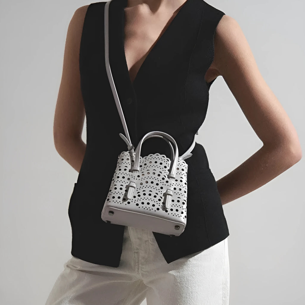 Hollow carved PU messenger bag with three adjustable straps in horizontal square shape