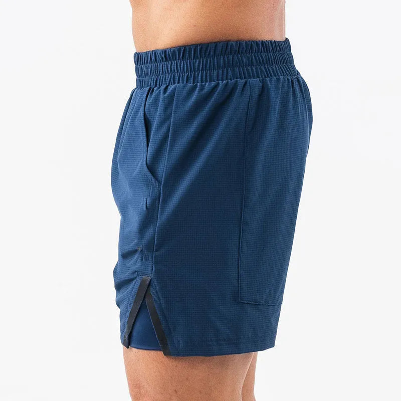 Man wearing quick-drying plaid sports shorts in army green, showing mid waist and shorts length.