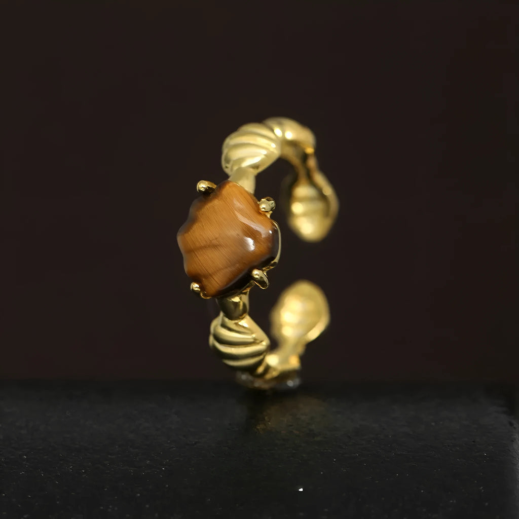 Adjustable silver ring with natural white shell and tiger eye detail, shown in white gold and 18K gold electroplated finishes.
