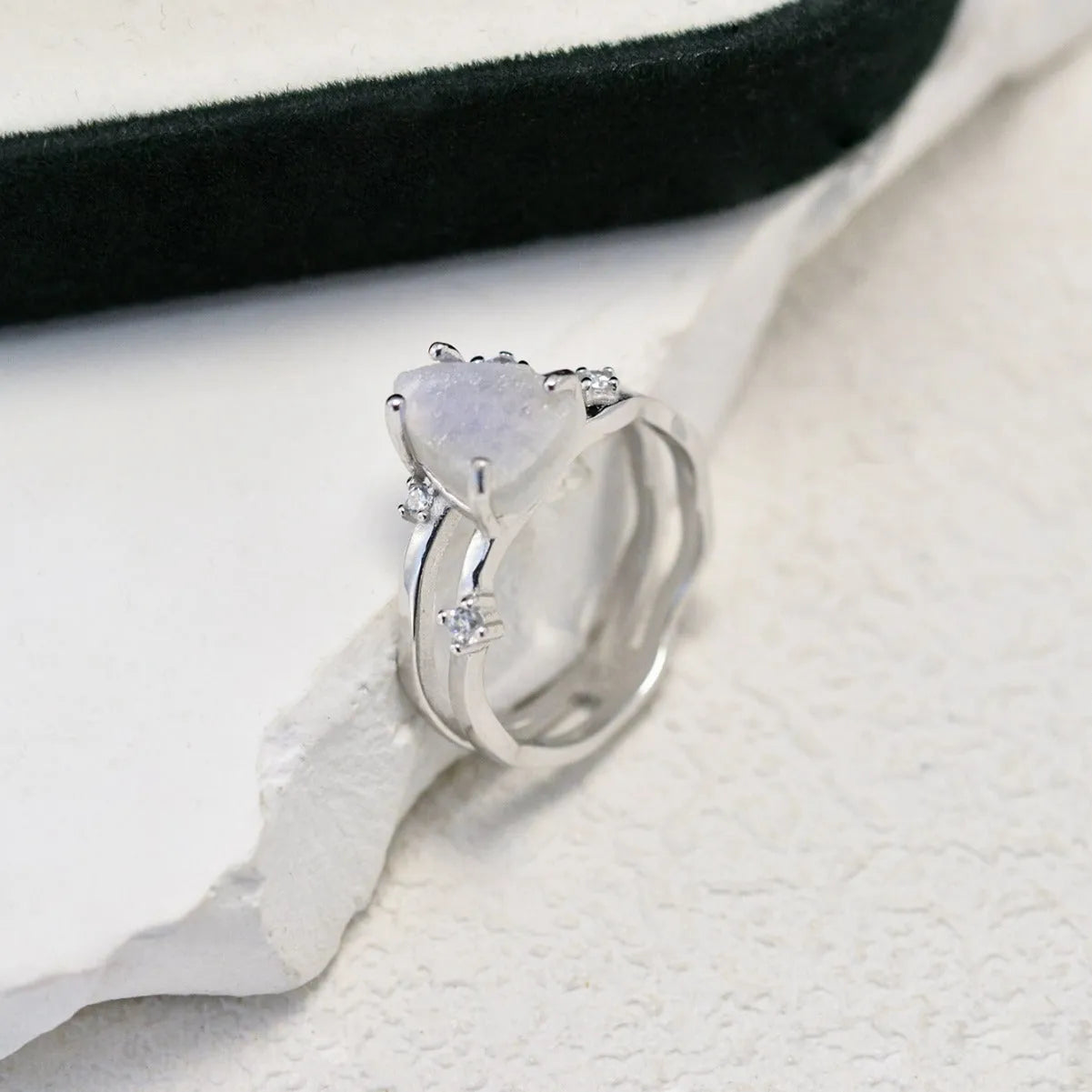 S925 silver ring with an irregular triangle-shaped moonstone in a geometric setting, shown in rose gold, white gold, and yellow gold finishes.