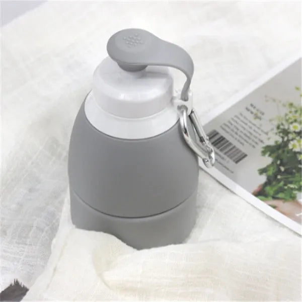 Blue silicone folding water bottle shown expanded and collapsed with measurement scale