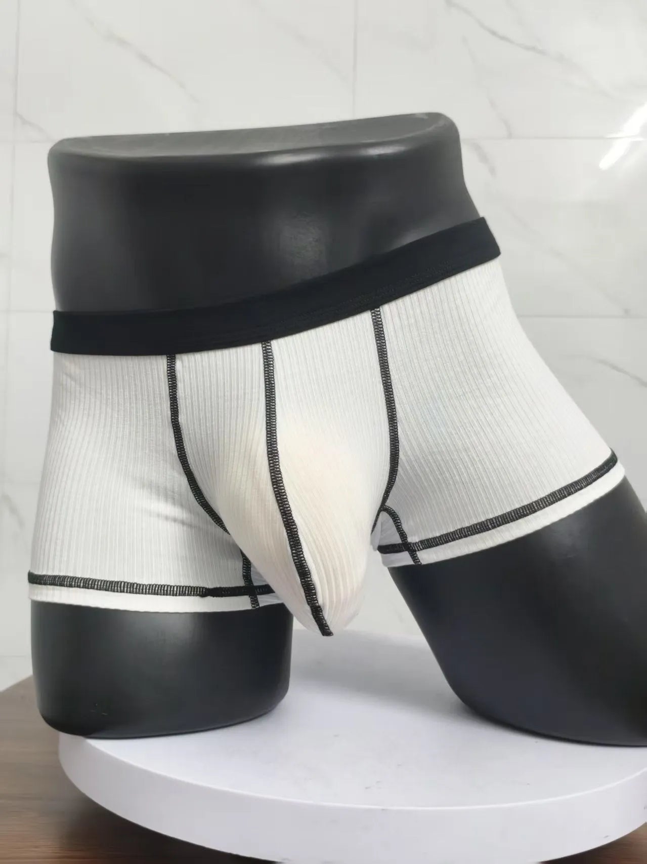 Men's solid colour breathable boxer shorts on a white background showing hip lifting design.