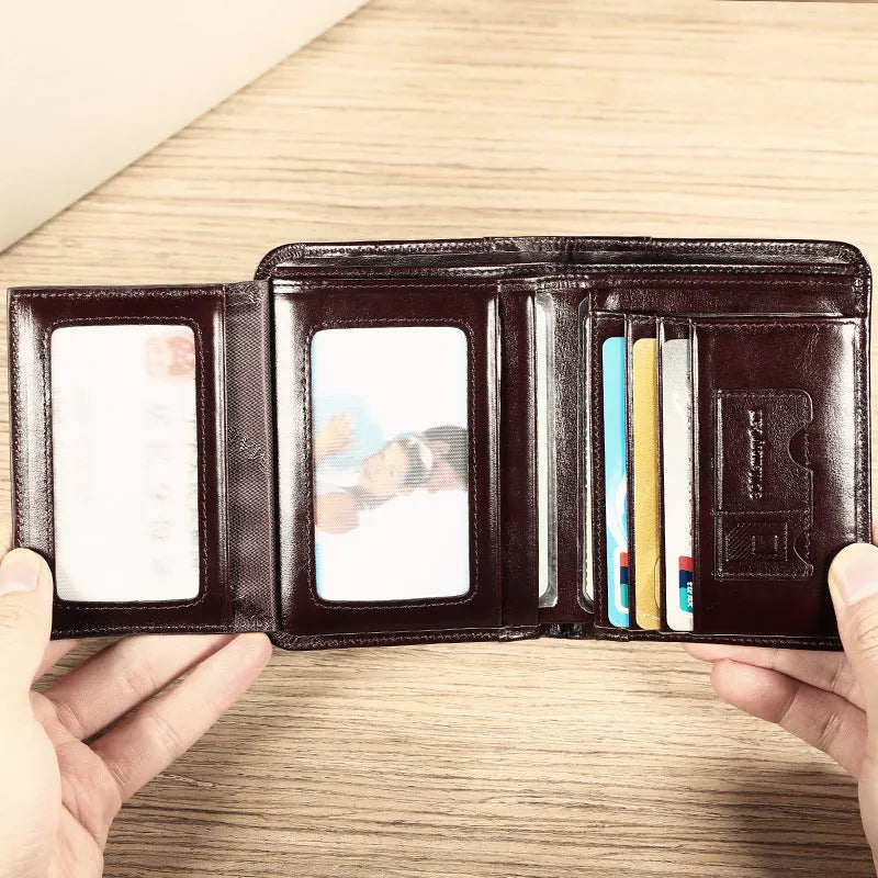 Men's black full-grain leather bifold wallet open, showing card slots, zip coin pocket, and banknote section.