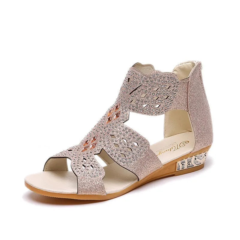 Women's flat open toe sandals with rhinestone details and a back zipper in gold.