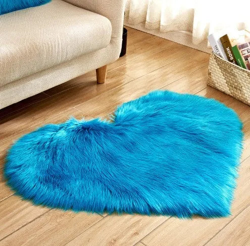 Heart-shaped plush carpet in multiple colours showing wool-like texture with 5-6 cm pile length