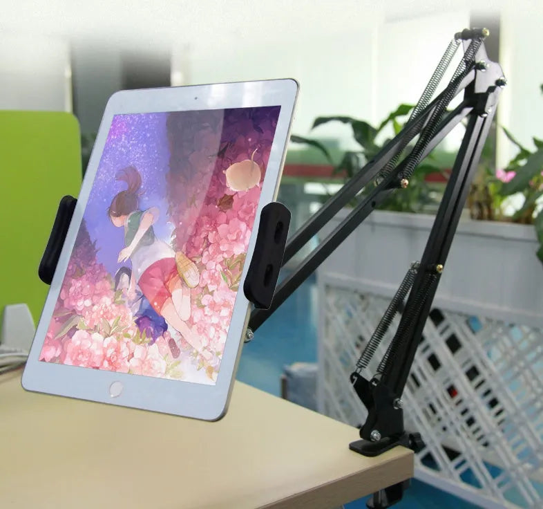 Adjustable black phone and tablet stand with 10cm base on a wooden desk
