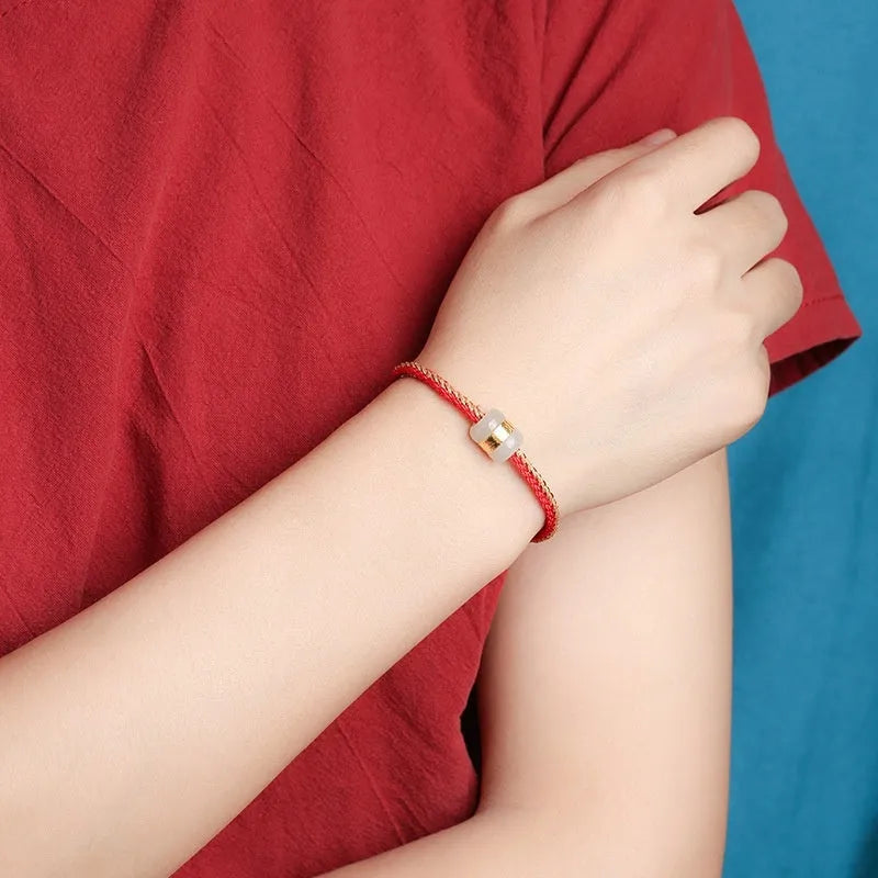 Hand-woven bracelet with Hetian jade inlay gold tone finish geometric shape on dark background