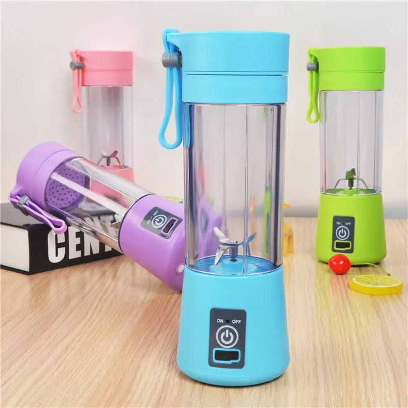 Mini USB-powered centrifugal fruit juicer in pink, with a 400ml plastic cup and stainless steel blade.