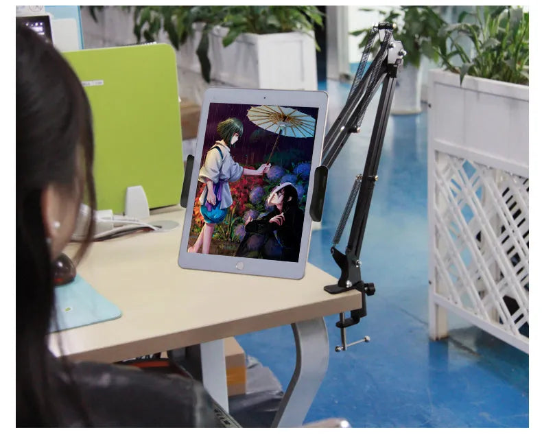 Adjustable black phone and tablet stand with 10cm base on a wooden desk