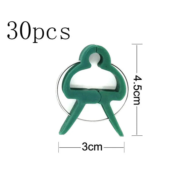 Green plastic and zinc plant fixing clips in large and small sizes for securing climbing plants.