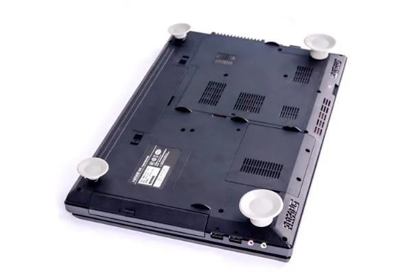 Four grey durable plastic laptop cooling pads, two large and two small, placed on a desk surface.