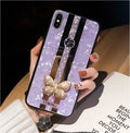 Luxury acrylic iPhone case with crystal butterfly design and mirror back, shown in purple.