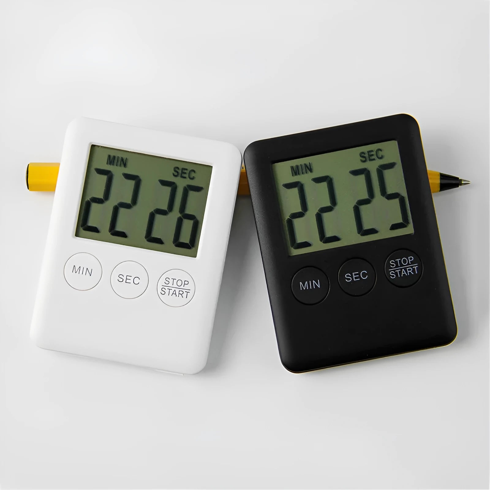 Black or white plastic digital kitchen timer with LCD display and magnetic back.