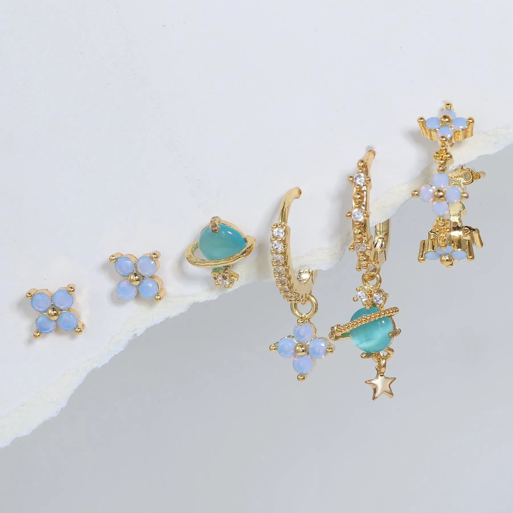 Gold and silver floral ear studs with blue zircon flower nail detail in Japanese Korean style