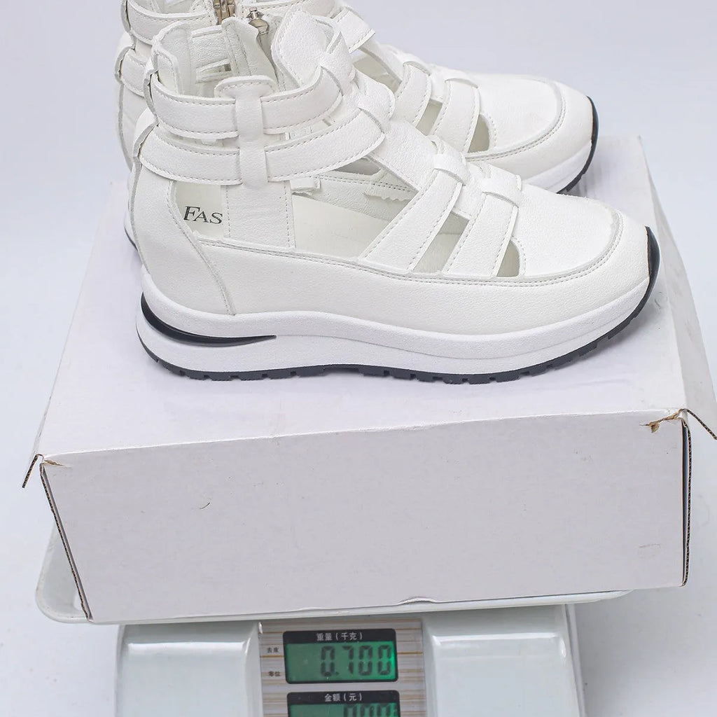 Women's black platform sandal with closed toe, hollow-out design, and Velcro ankle strap.