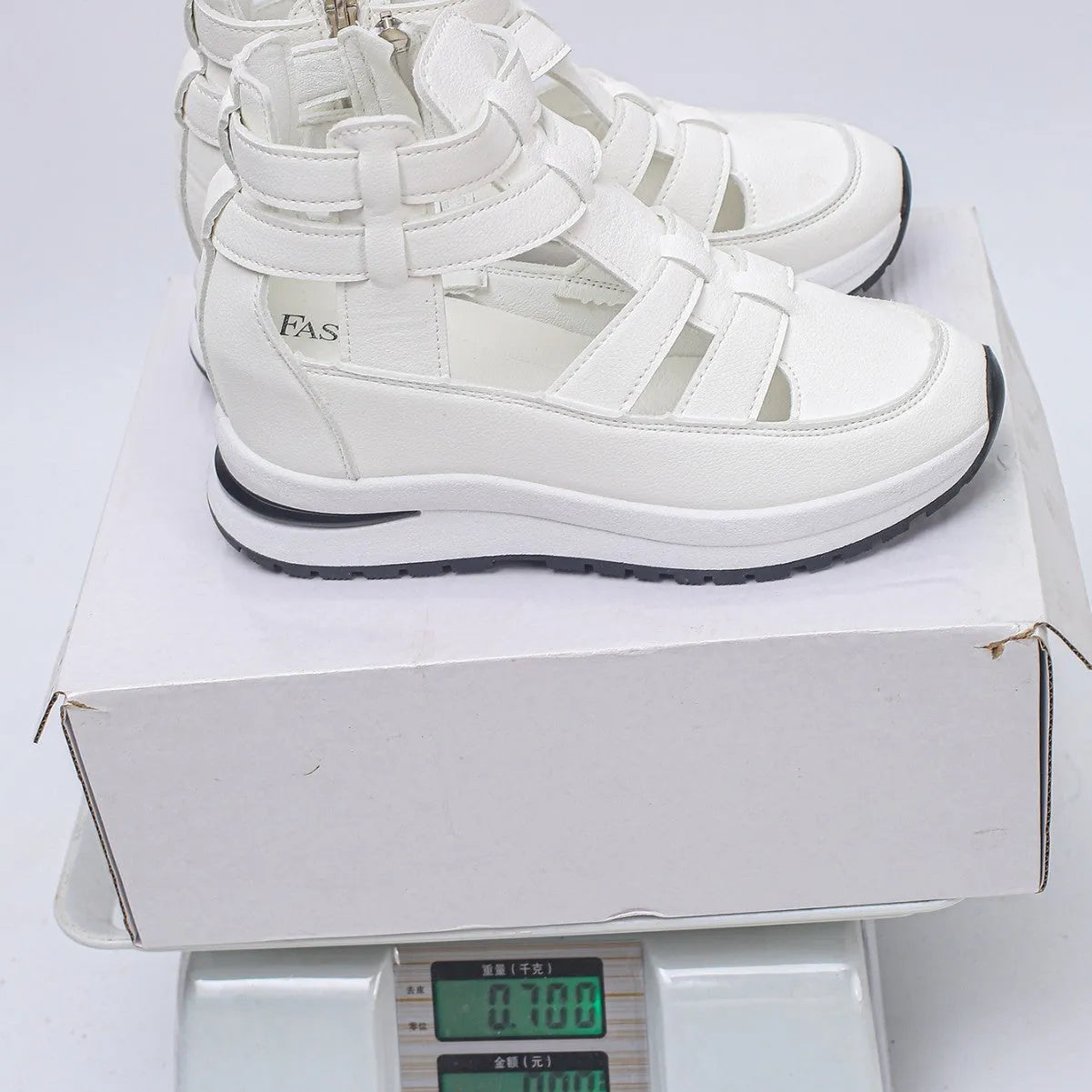 Women's black platform sandal with closed toe, hollow-out design, and Velcro ankle strap.