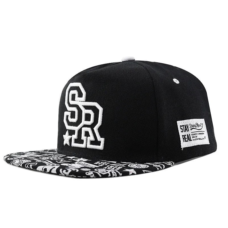 Adjustable black cotton baseball cap with white letter embroidery on the front, showing dome crown shape.