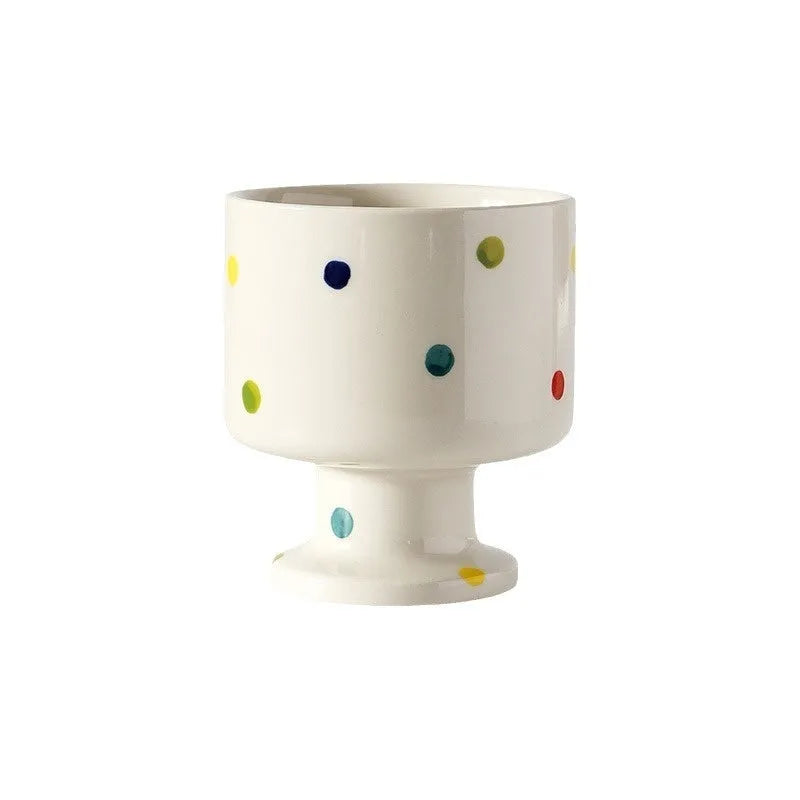 Handmade irregular solid colour ceramic mug on a table, showing its unique shape.