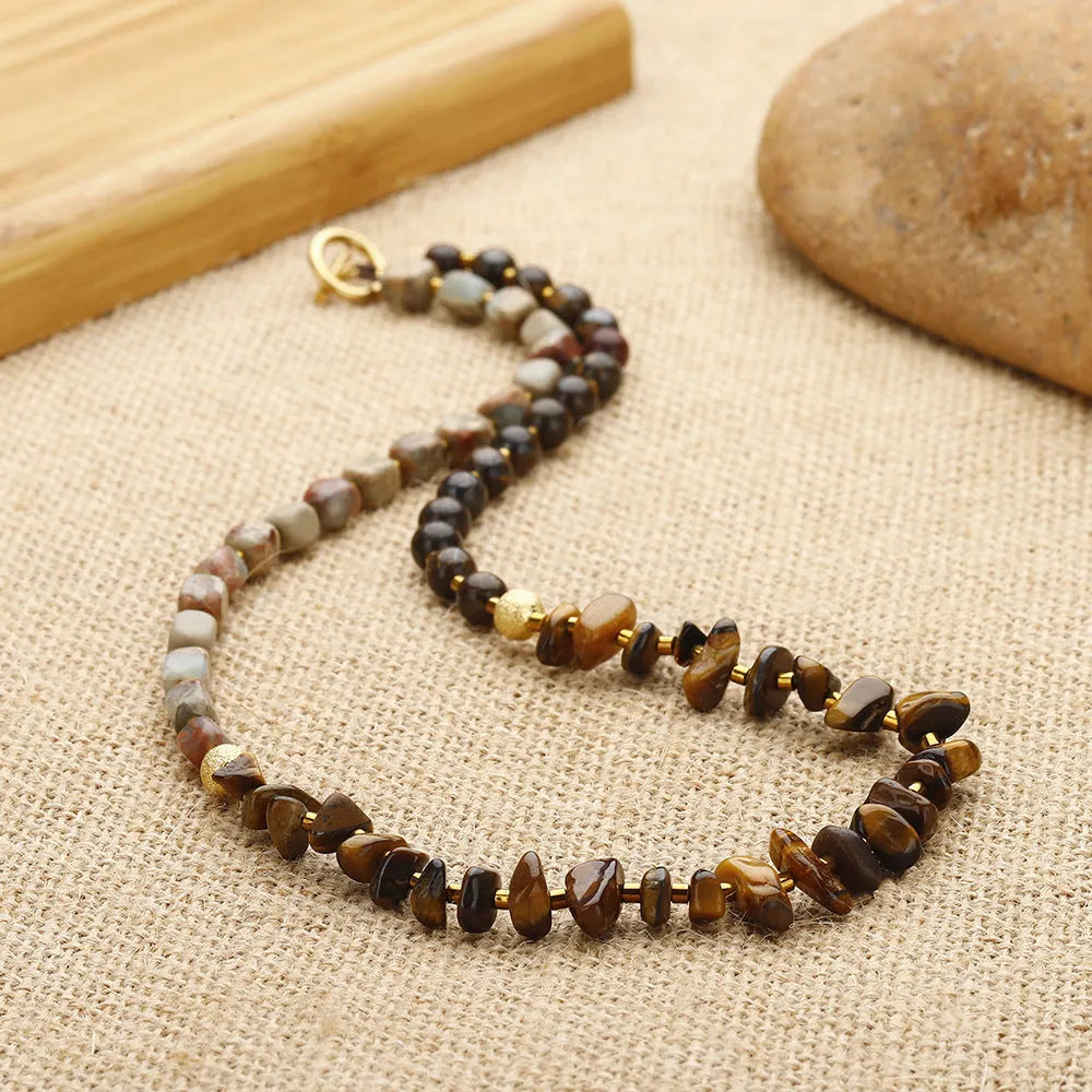 Tigereye stone and bronze geometric bracelet with glow ball design and texture details